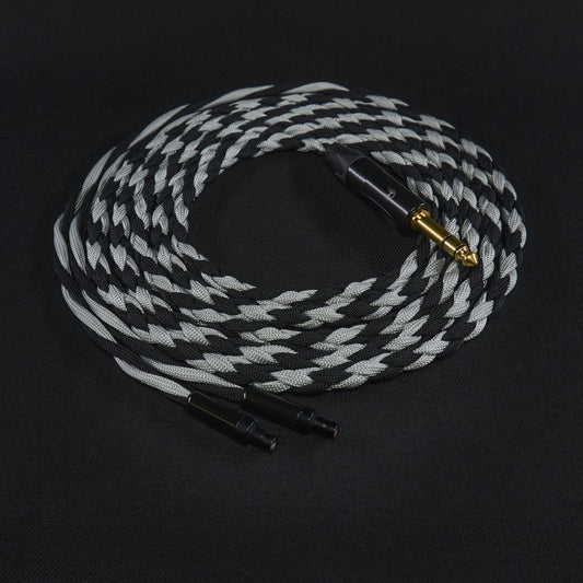 Braided audio cable with black and white pattern on a black background