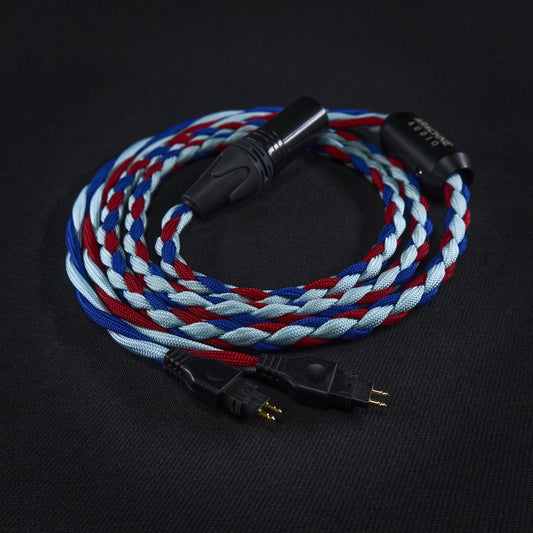 Braided audio cable with black connectors on a dark background