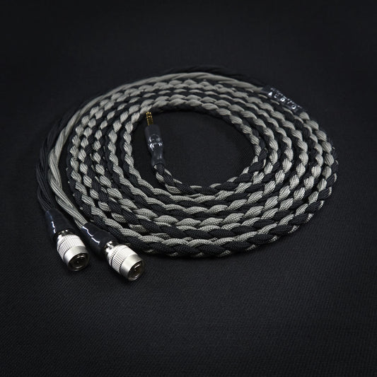 Coiled audio cable with braided design on a black background