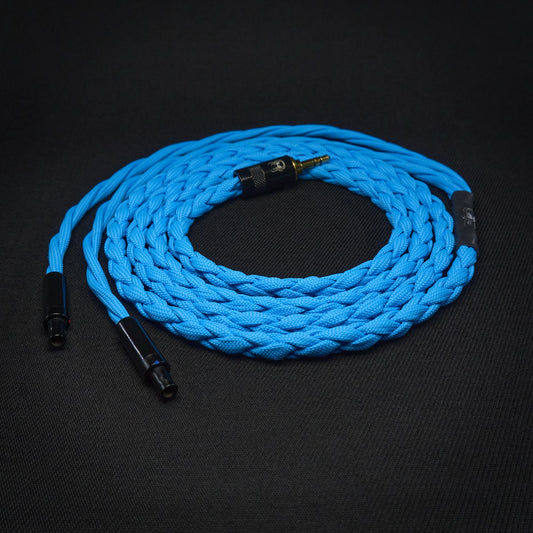 Coiled blue braided cable with connectors on a black background
