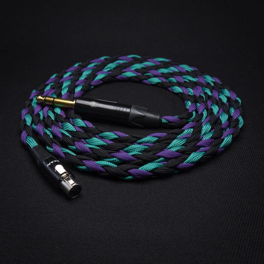 Braided audio cable with purple and green braiding on a black background