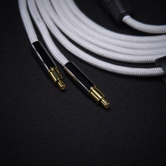 Close-up of audio cable with gold connectors on a dark background