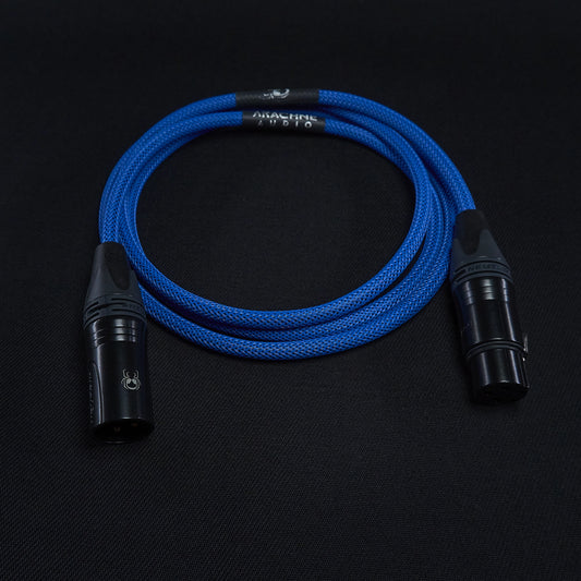 Blue sleeved microphone cable with black connectors on a black background