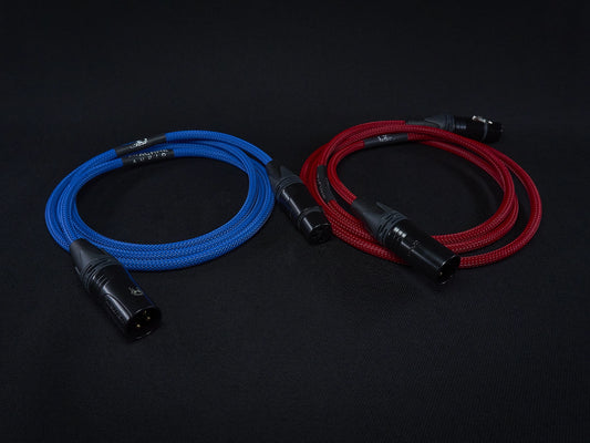 Two braided cables, one blue and one red, on a black background.