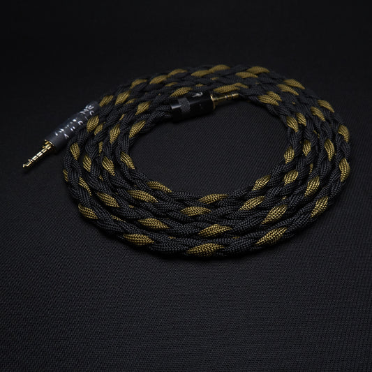 Black and gold braided audio cable on a black background