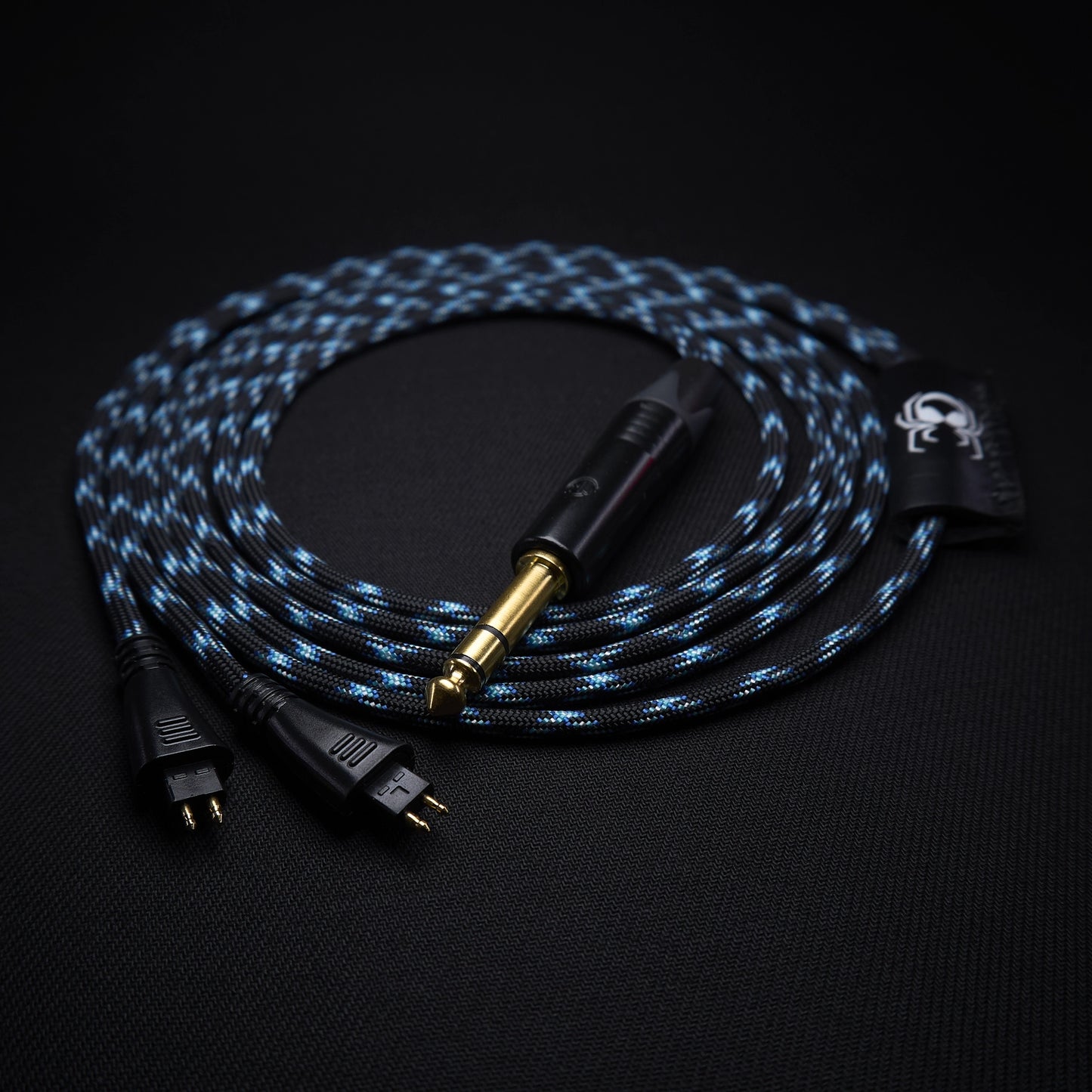 Braided audio cable with gold connector on a black background