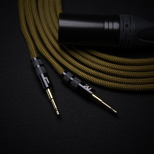 Audio cable with black plug on a dark background