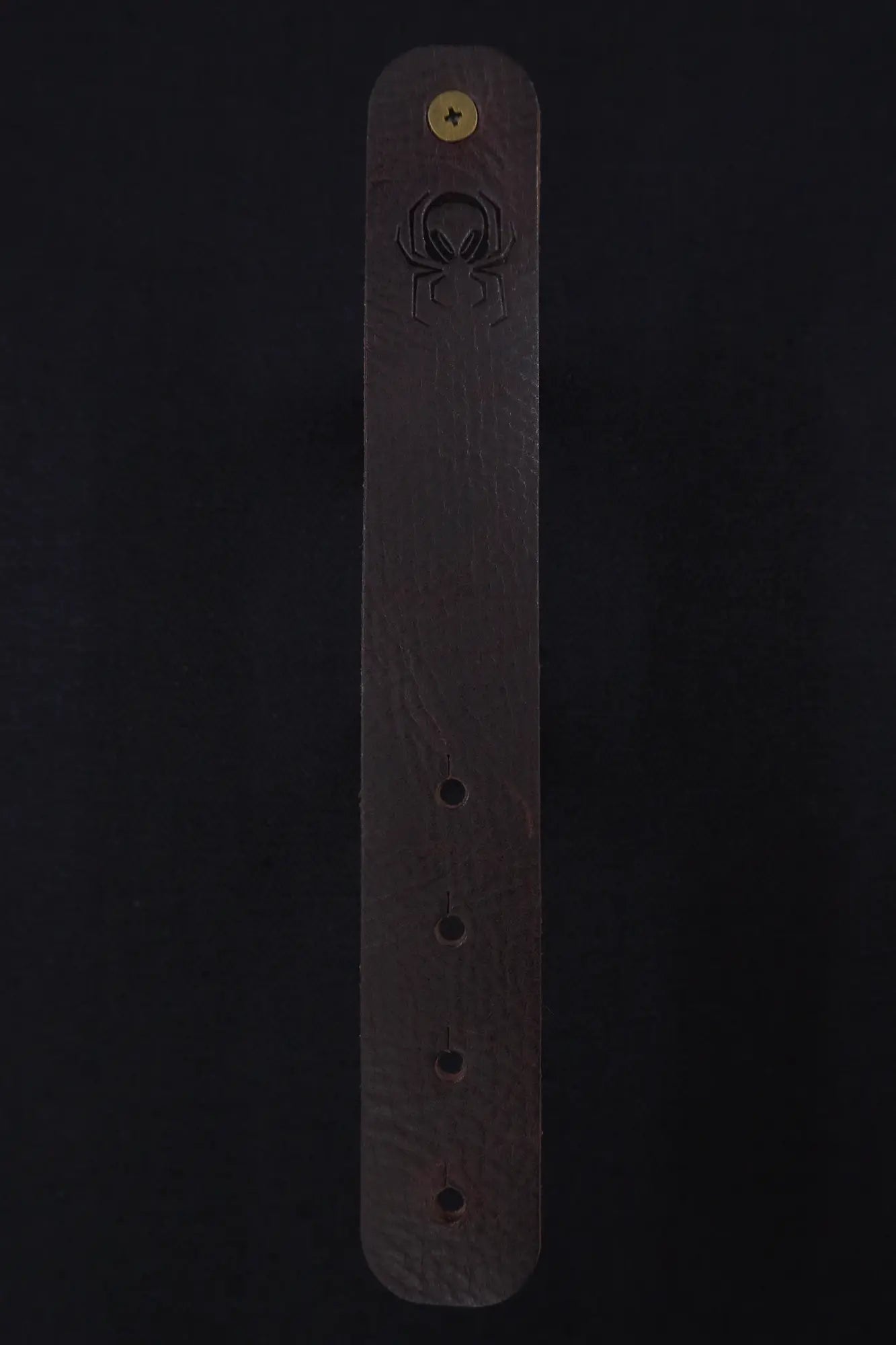 Fermata leather cable strap in Tobacco (tobacco brown) with brass stud and embossed Arachne spider
