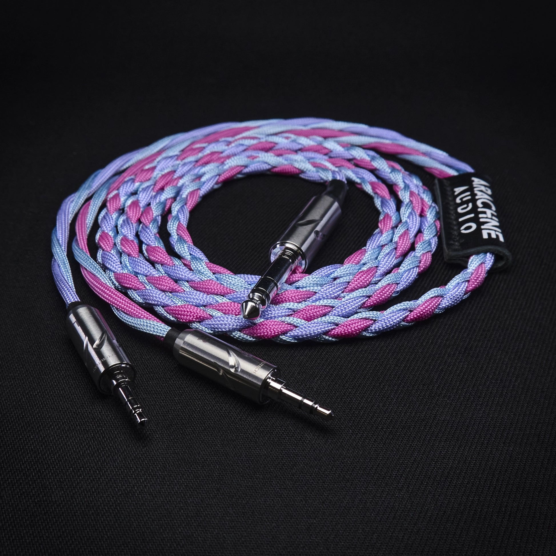 Braided audio cable with metal connectors on a black background