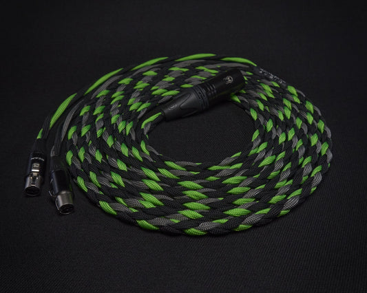 Braided audio cable with green and black design on a dark background