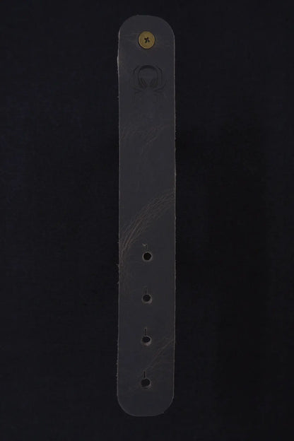 Fermata leather cable strap in Graphite (grey) with brass stud and embossed Arachne spider