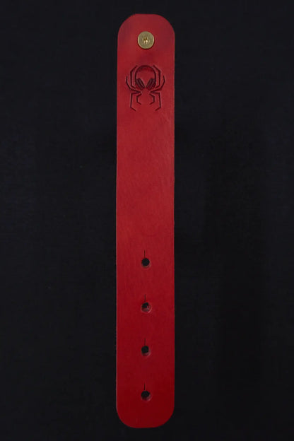 Fermata leather cable strap in Oxblood (red) with brass stud and embossed Arachne spider