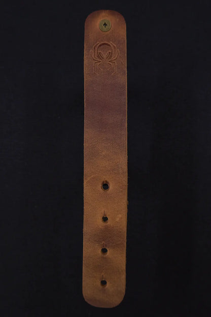 Fermata leather cable strap in Sienna (light brown) with brass stud and embossed Arachne spider