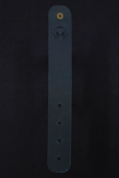 Fermata leather cable strap in Verdigris (teal) with brass stud and embossed Arachne spider